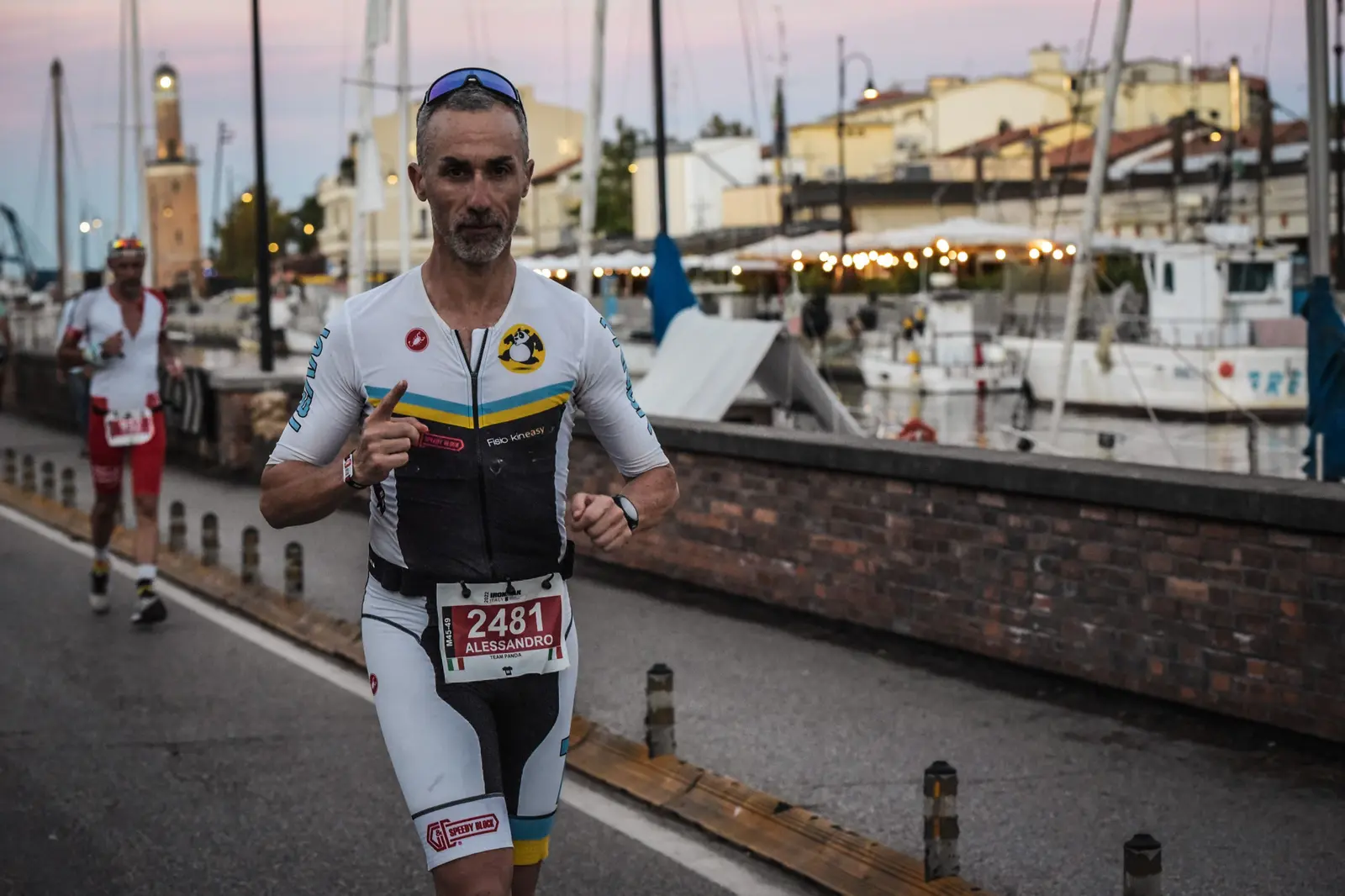 Atleta Team Panda corre da solo sul lungomare durante la frazione finale